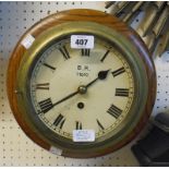 An 11" diameter polished oak cased wall timepiece with heavy brass bulkhead bezel and dial marked