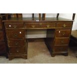 A 4' reproduction mahogany twin pedestal desk with leather inset top, three frieze drawers and