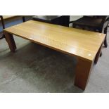 A 4' 5" modern polished wood coffee table, set on L-shaped legs