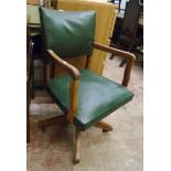 A vintage Hillcrest action office swivel chair with oak frame and studded green leatherette