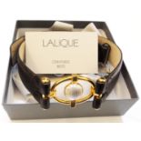 A boxed Lalique belt with central ribbed glass half sphere on ornate gilt metal buckle