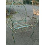A wire work garden elbow chair with metal slatted seat