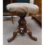 A Victorian rosewood adjustable piano stool, set on reeded bulbous pillar and cabriole scroll tripod