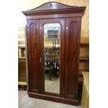 A 4' 3" Edwardian mahogany wardrobe with moulded cornice and hanging space with locker compartment