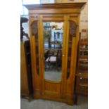 A 3' 6" Edwardian satin walnut wardrobe with moulded cornice, hanging space enclosed by a bevelled