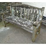 A 5' 1" teak garden bench of slatted design