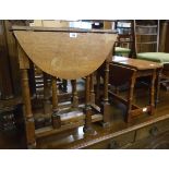 A 24" antique oak gateleg table set on turned supports - sold with a later swivel top occasional