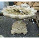 A 17" high Classical style shell pattern bird bath with scroll decoration