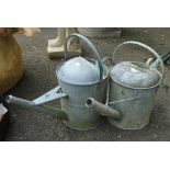 Two galvanized watering cans