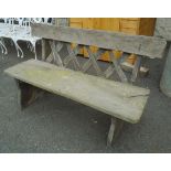 A 4' 6 1/2" rustic garden bench with lattice back