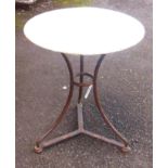 A 23½" diameter patio table with circular sheet metal top set on wrought iron tripod base