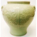 An 11" high Chinese celadon vase with lion head handles and impressed decoration
