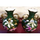 A pair of Victorian two handled faceted baluster vases with handpainted floral decoration