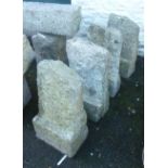 Four similar shaped granite quoin stones