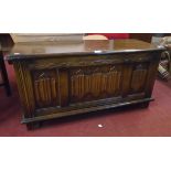 A 3' 2" 20th Century polished oak blanket chest with linen fold decoration to front