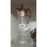 A cut glass claret jug with silver plated mounts, satyr mask spout and grapevine scroll handle