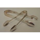 A pair of Victorian silver fiddle pattern sugar tongs and a pair of silver plated similar