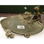 An Art Nouveau WMF silver plated visiting card tray with woman lying beside a pool, marked 'EP'