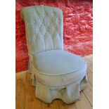 A Victorian upholstered button back nursing chair, set on turned front legs and casters