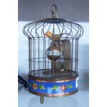 A bird in a cage automaton alarm clock with decorative cloisonné style border to base