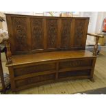 A 4' 8" oak settle with five panel slightly curved back and armrests with turned supports, set on