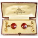 A Page, Keen & Page boxed pair of 15ct. gold cuff-links with red enamelled panels