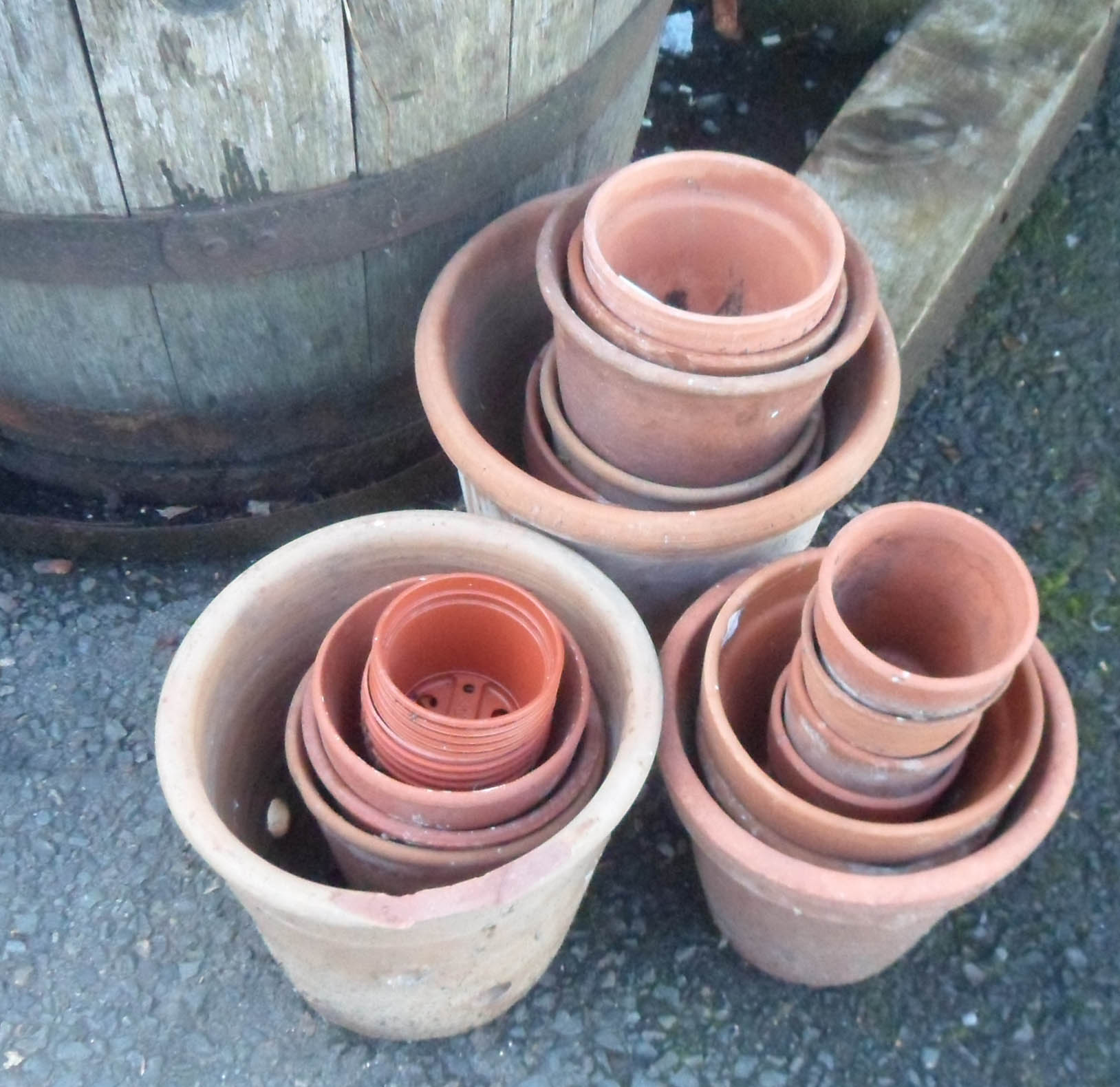 A quantity of terracotta and other plant pots