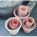 A quantity of terracotta and other plant pots