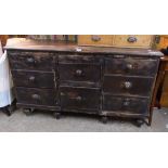 A 4' 10" Victorian stained pine dresser base with two central deep drawers and six flanking