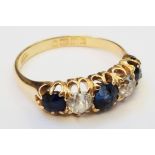 An 18ct. gold ring, set with three sapphires interspersed with two old cut diamonds - Birmingham