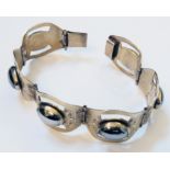 A Mexican marked "Sterling .925" gilt metal panel-link bracelet, set with cabochon hematite oval