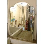 A 32" Art Deco frameless wall mirror with scalloped top and decorative bevelled plate