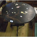 A 24" diameter japanned pedestal table with remains of painted and inlaid perching bird decoration