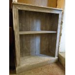 A 33" painted pine two shelf open bookcase with moulded decoration and plinth base