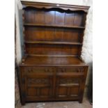 A 4' 20th Century polished oak two part dresser in the antique style with two shelf open plate rack,