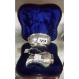 A leather clad cased silver plated cream jug and sugar bowl with parcel gilt interiors