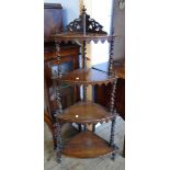A 19th Century rosewood corner what-not with four graduated tiers set on barley twist supports