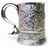 A 5¼" George II silver tankard with all-over embossed C-scroll and floral decoration, cast shell