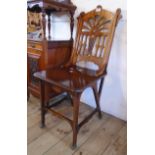 An early 20th Century mahogany chair with decorative pierced splat back, solid seat panel and