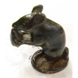 A miniature bronze figure of a mouse eating a nut, initialled W.R.L. to base