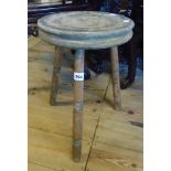 An old milking stool with turned legs