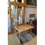 A modern stained mixed wood high stick back rocking chair with ring turned supports