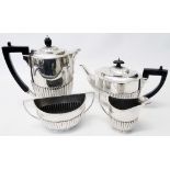 A silver tea set of semi-reeded design, comprising teapot, hot water jug, sugar bowl and cream jug