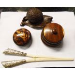 Three pieces of treen comprising an inkwell in the form of a chestnut on a leaf, desk weight with