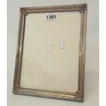 A marked Peru 925 white metal fronted photograph frame with polished wood easel back - to take 8"