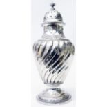 An 8" late Victorian silver sugar caster with embossed floral and twist decoration - Sheffield 1893