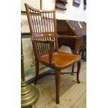 An Edwardian mahogany framed spindle back office elbow chair, set on cabriole front legs with X-