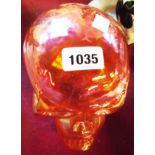 An orange lustre glass skull