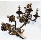 A pair of continental gilt metal three branch wall brackets with pierced decoration