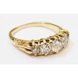 An 18ct. gold ring, set with five graduated old cut diamonds